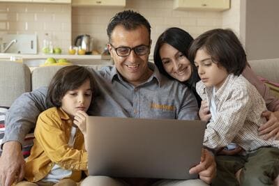 family looking together laptop home